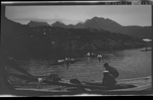 Image: Several kayakers. Kayak in large boat